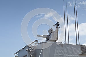 CIWS mounted on battleship gray frigate in harbour photo