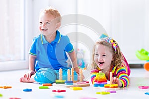 Cjildren playing with wooden toys