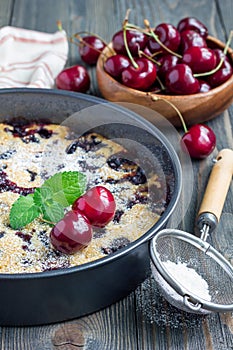 Clafoutis with cherry in baking dish, vertical