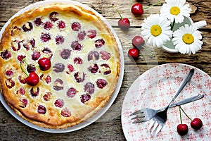 Clafoutis cherry pie on rustic background