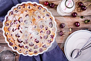 Clafoutis cherry pie on wooden background