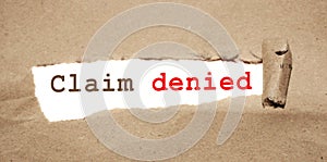 Claim Denied. phrase text under torn paper. Insurance and Warranty concept