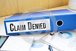 Claim Denied words on labels with document binders