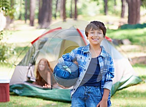 Claiming his camping spot. A boy standing in front of his campsite.