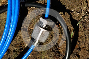 Clamping bush and seal bushing of heating cable for water supply pipes close-up.