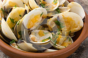 Clams with marinera sauce. Almejas a la marinera. Spanish recipe on wood