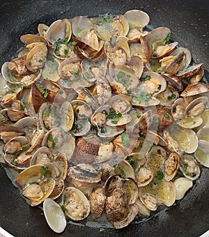 The clams seasoned while cooking in a pan