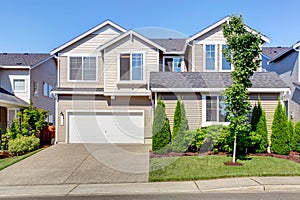 Clapboard sidinig house. Garage with driveway and curb appeal