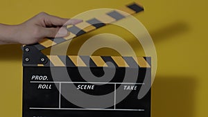Clapper board. Close up hand and film making clapperboard isolated on background