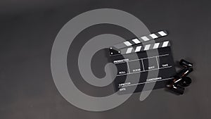 Clapper board or movie slate and film rolls on black background. it used in video production and film industry.