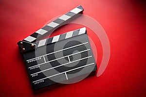Clapper board on red background photo