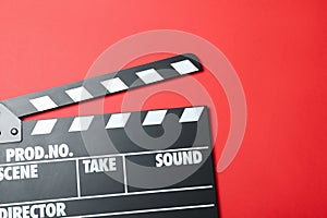 Clapper board on red background, top view. Cinema