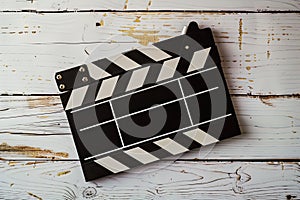 Clapper board on a white wooden surface, cinema and videomaking concept