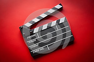 Clapper board on red background photo