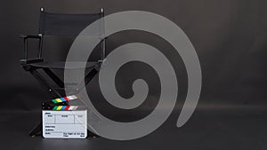 Clapperboard or clap board or movie slate with director chair use in video production ,film, cinema industry on black background