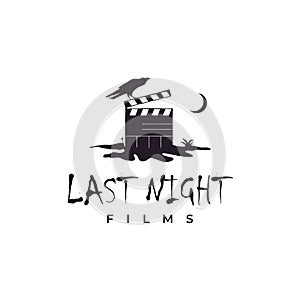 Clapperboard on cracked ground at night and crow illustration logo. Horror movie logo design inspiration