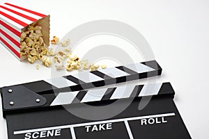 Clapperboard or movie slate black color with popcorn. Cinema industry and video production concept.