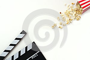 Clapperboard or movie slate black color with popcorn. Cinema industry, video production and film concept.