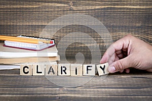 Clarify. Wooden letters on the office desk