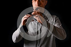 Clarinet in the hands of a man on a black background