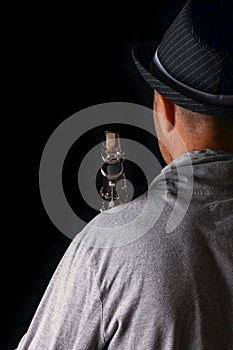 Clarinet in the hands of a man on a black background