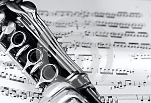 Clarinet on music partiture background photo