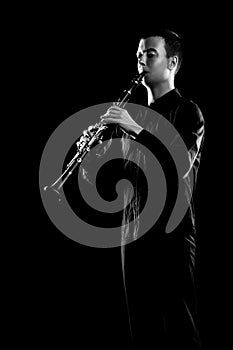 Clarinet player classical musician  on black. Clarinetist playing music instrument