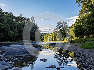 Clarion River in Cooks Forest State Park in Pennsylvania right before sunset with a soft sky reflecting in the river and the