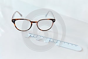 Clarity comes in pairs. Shot of a pair of glasses and a pd ruler in an optometrists office.