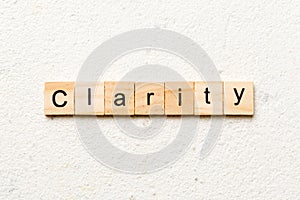 clarity word written on wood block. clarity text on table, concept