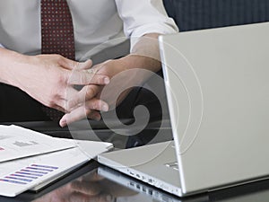 Clasped Business Hands By Laptop