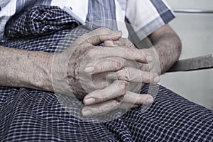 Clasped hands of Asian man. Concept of rheumatoid arthritis, osteoarthritis or joint pain