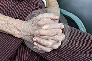 Clasped hands of Asian man. Concept of rheumatoid arthritis, osteoarthritis or joint pain