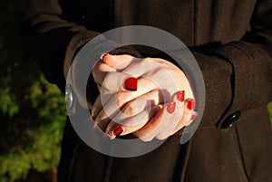 Clasped Hands with Long Red and Black Fingernails