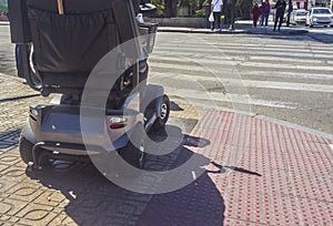 Class 3 mobility scooter wainting at at pedestrian crossing