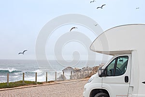 RV and the Scenic Sea. Road Trip Camping. Recreation Vehicle Theme photo