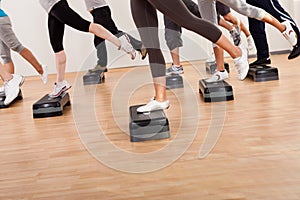 Class doing aerobics balancing on boards