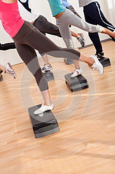 Class doing aerobics balancing on boards