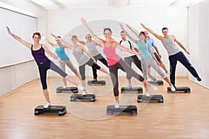 Class doing aerobics balancing on boards