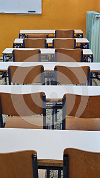 class of elemantary school desk chairs board empty