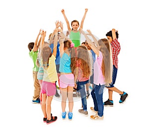 Class leader girl raised hands in circle of mates