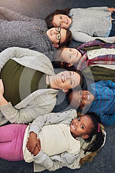 Class photos should look something like this. Portrait of a group of elementary school kids and their teacher lying down