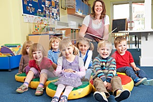 Class Of Pre School Children At Story Time With Teacher