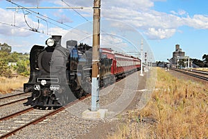 A-class steam engine hauling red rattler carriages at Sunshin