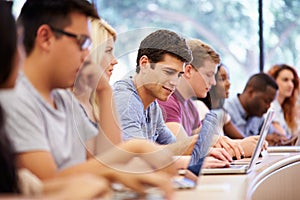 Class Of University Students Using Laptops In Lecture