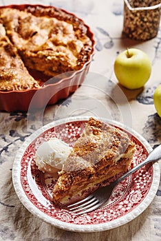 Classic American apple pie served with ice cream on linen tablecloth