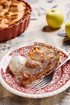 Classic American apple pie served with ice cream on linen tablecloth