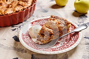 Classic American apple pie served with ice cream on linen tablecloth