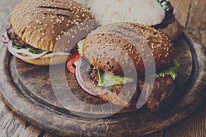 Classic american burgers, fast food on wood background