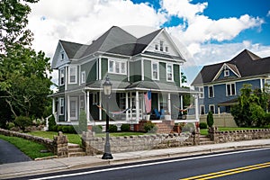 classic American house colonial style. Veranda with columns and flag at entrance